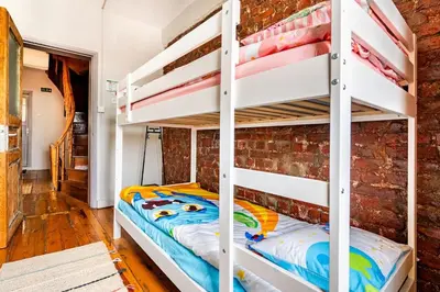 a bedroom with a bunk bed and a brick wall at Timeless House Overlooking the Golden Horn with Sea - Nilorayn in Istanbul