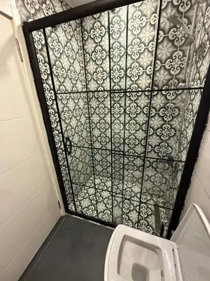 a small bathroom with a toilet and a wall at AYD Apartment Taksim in Istanbul