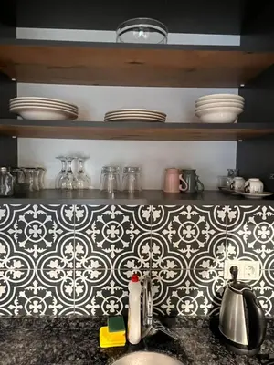 a kitchen with black and white tile on the wall at AYD Apartment Taksim in Istanbul
