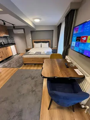 a bedroom with a bed and a large screen television at AYD Apartment Taksim in Istanbul