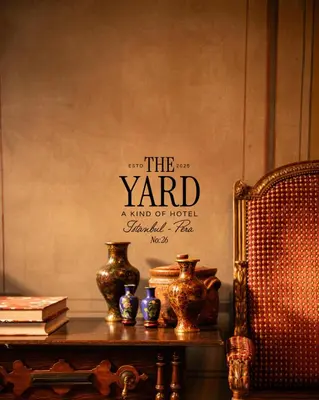a room with a table with vases on it at The Yard Hotel in Istanbul