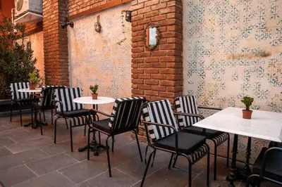 a row of tables and chairs on a patio at The Yard Hotel in Istanbul