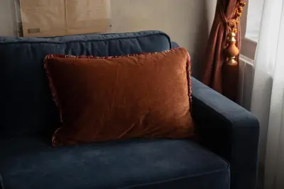 a blue couch with a brown pillow on it at The Yard Hotel in Istanbul