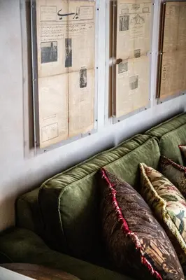 a green couch with two pillows in a living room at The Yard Hotel in Istanbul