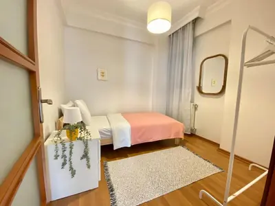 a small room with a bed and a mirror at Central Location 3 Bedroom Flat - No6 in Istanbul