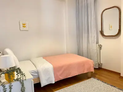 a small room with a bed and a mirror at Central Location 3 Bedroom Flat - No6 in Istanbul
