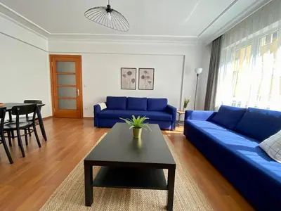 a living room with a blue couch and a table at Central Location 3 Bedroom Flat - No6 in Istanbul