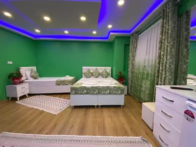 a green room with two beds and purple lighting at Işıl Otel Old City in Istanbul