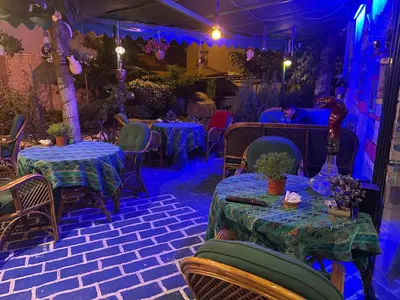 a restaurant with tables and chairs with blue lights at Işıl Otel Old City in Istanbul