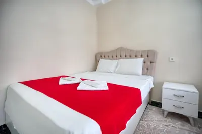 a bedroom with a bed with a red blanket at Işıl Otel Old City in Istanbul