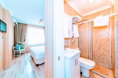 a small bathroom with a toilet and a sink at Walnut Shell Hotel in Istanbul
