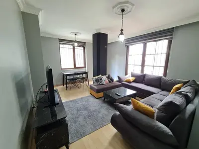 a living room with a couch and a table at Specius Flat Near Yeditepe Univ in Istanbul