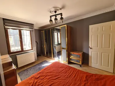 a bedroom with a bed and a large mirror at Specius Flat Near Yeditepe Univ in Istanbul
