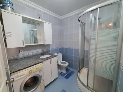 a bathroom with a washing machine and a toilet at Specius Flat Near Yeditepe Univ in Istanbul