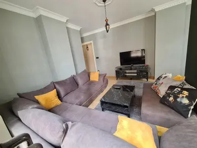 a living room with a couch and a flat screen tv at Specius Flat Near Yeditepe Univ in Istanbul