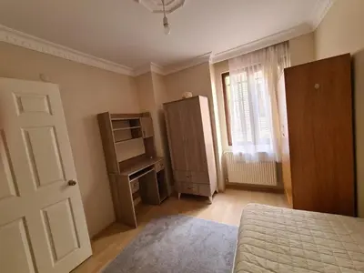 a bedroom with a bed and a cabinet and a window at Specius Flat Near Yeditepe Univ in Istanbul