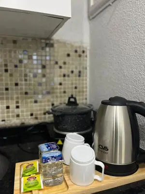 a kitchen counter with a tea kettle and cups on it at Taksim Dolunay Suites in Istanbul