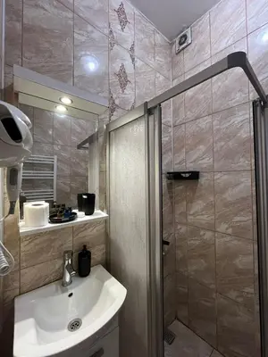 a bathroom with a sink and a shower at Taksim Dolunay Suites in Istanbul