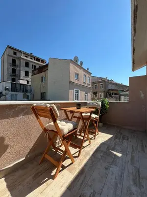 a patio table and chairs on a roof at Taksim Dolunay Suites in Istanbul