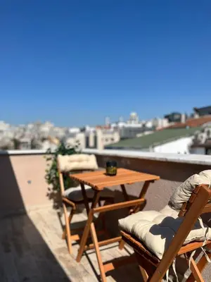 a table and chairs on a balcony with a view at Taksim Dolunay Suites in Istanbul