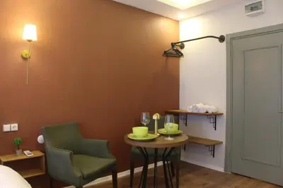 a room with a table and two chairs and a bed at PeraHomes DE in Istanbul