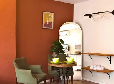 a dining room with a table and chairs and a mirror at PeraHomes DE in Istanbul