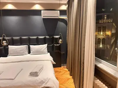 a bedroom with a bed with a black headboard at Riddim apartment in Istanbul