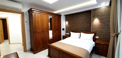 a bedroom with a large bed and a wooden wall at Taksim Flat in Istanbul