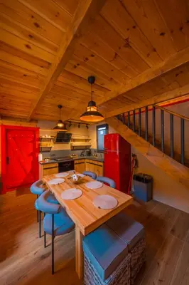 a kitchen with a wooden table and blue chairs at Localita Sapanca in Sapanca