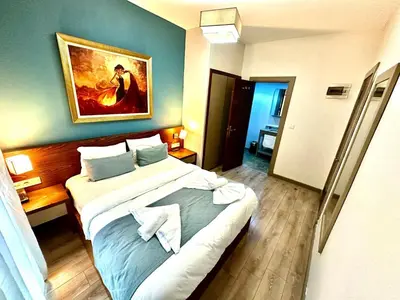 a hotel room with a bed with a painting on the wall at Taksim Luxury Beyoğlu Suites in Istanbul