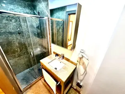 a bathroom with a sink and a shower at Taksim Luxury Beyoğlu Suites in Istanbul