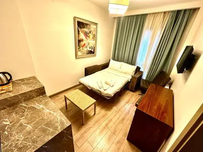 a small living room with a bed and a table at Taksim Luxury Beyoğlu Suites in Istanbul