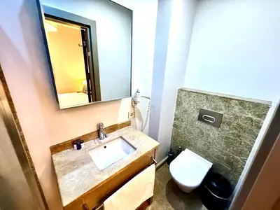 a bathroom with a sink and a toilet and a mirror at Taksim Luxury Beyoğlu Suites in Istanbul