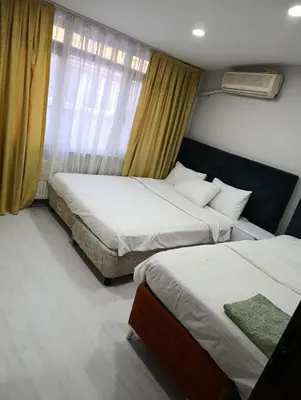 a hotel room with two beds and a window at BlueRoyal Home Sultanahmet in Istanbul
