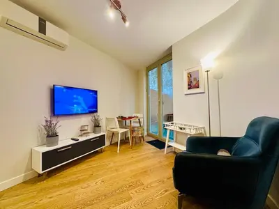 a living room with a couch and a tv at Beyoglu Hacımimi Gardens içinde özel bahçeli daire in Istanbul