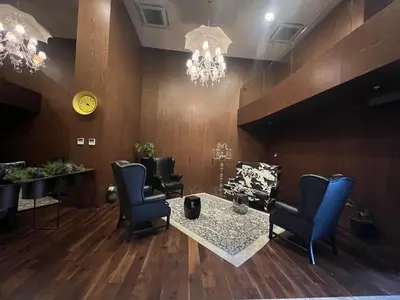 a salon with chairs and a table and a chandelier at CIFT MANZARa in Istanbul