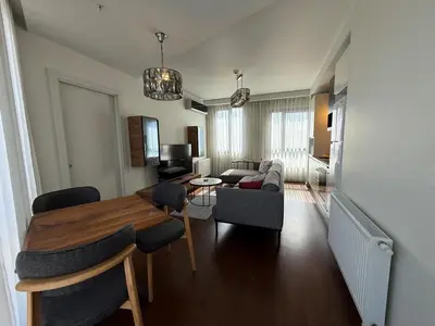 a living room with a dining table and a couch at CIFT MANZARa in Istanbul