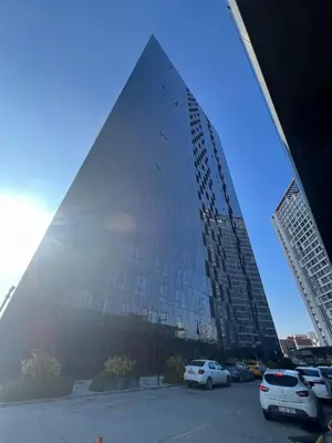 a tall building with cars parked in a parking lot at CIFT MANZARa in Istanbul
