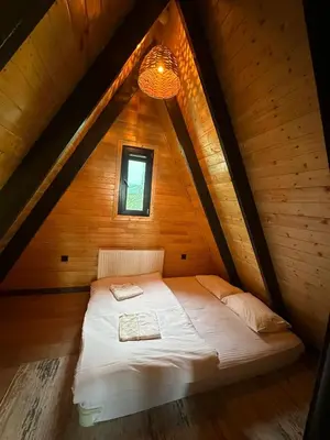 a bed in a wooden room in a attic at Reborn sapanca in Sapanca