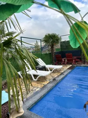a swimming pool with two lounge chairs next to a swimming pool at Reborn sapanca in Sapanca