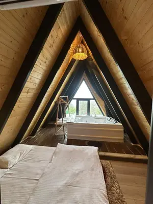 a room with a bed and a window in a attic at Reborn sapanca in Sapanca