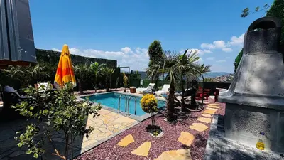 a backyard with a swimming pool and a umbrella at Reborn sapanca in Sapanca