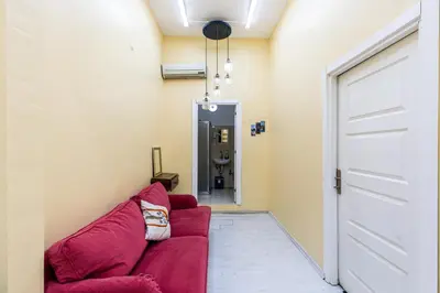 a living room with a red couch and a door at Galata Comfortable 12 Suits in Istanbul