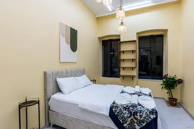 a bedroom with a bed in a room with windows at Galata Comfortable 12 Suits in Istanbul