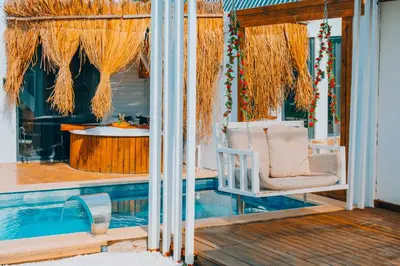 a porch with a chair next to a swimming pool at 777Sapanca Bungalov Konaklama in Sapanca