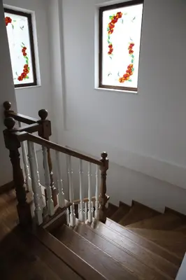 a staircase with two stained glass windows in a house at Guzel Evler Family Resort in Sapanca