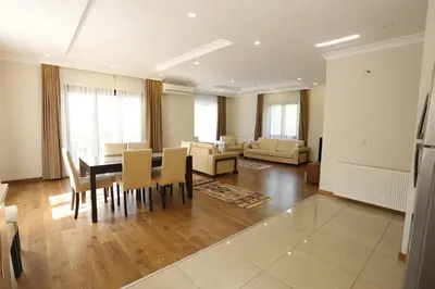 a dining room and living room with a table and chairs at Guzel Evler Family Resort in Sapanca