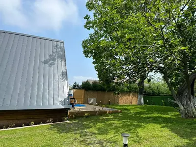 a yard with a building and a tree at Guzel Evler Family Resort in Sapanca