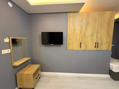 a room with a bed and a tv on a wall at Atay Apart in Istanbul