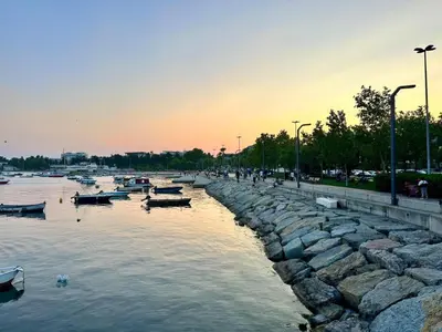 a group of boats in a river at sunset at Şeker Apartments in Tuzla